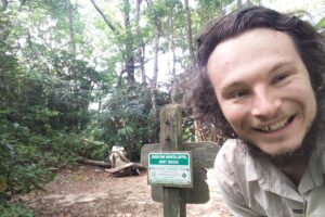 Dr. Matthew Pearce smiles for a selfie at an Appalachian Trail trail head