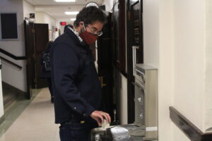 Dr. Edward Driggers fills up his cup at a water fountain in Henderson Hall.